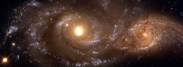 Strong tidal forces from the larger galaxy, cataloged as NGC 2207 (left), have distorted the shape of the smaller one, IC 2163 (right), flinging out stars and gas into long streamers stretching out a hundred thousand light-years. (copyright GRIN)